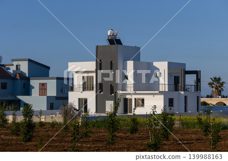 Modern architecture blends with nature in a sunny Mediterranean landscape Modern architecture blends with nature in a sunny Mediterranean landscape 139988163