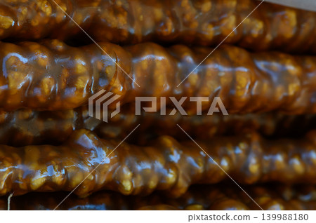 Deliciously sticky dessert treats showcasing rich textures and vibrant sweetness from a popular market stall Deliciously sticky dessert treats showcasing rich textures and vibrant sweetness from a popular market stall 139988180