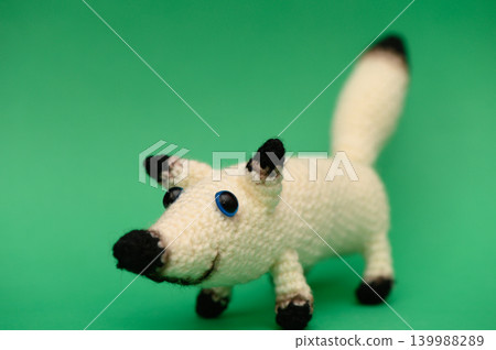 Handmade Knitted White Dog on Green Background Handmade Knitted White Dog on Green Background 139988289