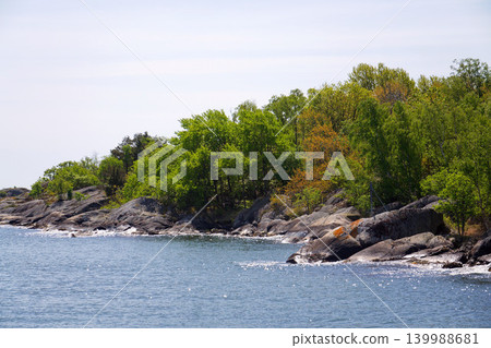 Beautiful trees and rocks on shore of Gothenburg archipelago islands, Gothenburg Minucipality, Vastra Gotaland County, Sweden, sunny day Beautiful trees and rocks on shore of Gothenburg archipelago islands, Gothenburg Minucipality, Vastra Gotaland County, Sweden, sunny day 139988681