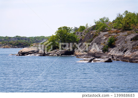 Beautiful trees and rocks on shore of Gothenburg archipelago islands, Gothenburg Minucipality, Vastra Gotaland County, Sweden, sunny day Beautiful trees and rocks on shore of Gothenburg archipelago islands, Gothenburg Minucipality, Vastra Gotaland County, Sweden, sunny day 139988683