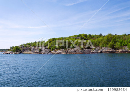 Beautiful trees and rocks on shore of Gothenburg archipelago islands, Gothenburg Minucipality, Vastra Gotaland County, Sweden, sunny day Beautiful trees and rocks on shore of Gothenburg archipelago islands, Gothenburg Minucipality, Vastra Gotaland County, Sweden, sunny day 139988684
