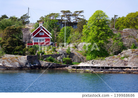 Beautiful holiday cottages on shore of Gothenburg archipelago islands, Gothenburg Minucipality, Vastra Gotaland County, Sweden, sunny day Beautiful holiday cottages on shore of Gothenburg archipelago islands, Gothenburg Minucipality, Vastra Gotaland County, Sweden, sunny day 139988686