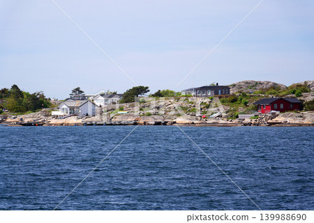 Beautiful holiday cottages on shore of Gothenburg archipelago islands, Gothenburg Minucipality, Vastra Gotaland County, Sweden, sunny day Beautiful holiday cottages on shore of Gothenburg archipelago islands, Gothenburg Minucipality, Vastra Gotaland County, Sweden, sunny day 139988690