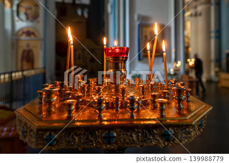 Lit Votive Candles on Ornate Altar in Orthodox Church Interior for Prayer and Worship Lit Votive Candles on Ornate Altar in Orthodox Church Interior for Prayer and Worship 139988779