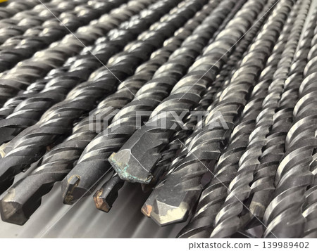 Collection of sturdy drill bits lined up for construction tasks at sunrise Collection of sturdy drill bits lined up for construction tasks at sunrise 139989402
