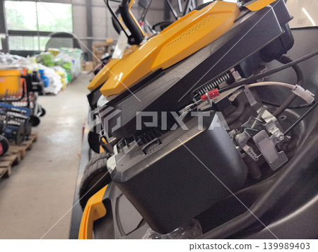 Exploring the inner workings of a modern lawnmower in a garden center Exploring the inner workings of a modern lawnmower in a garden center 139989403