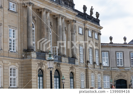 Exterior facade of Amalienborg Palace with Danish Royal Flag in Copenhagen, Denmark. Exterior facade of Amalienborg Palace with Danish Royal Flag in Copenhagen, Denmark. 139989416