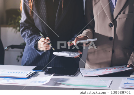 Accountants processing financial documents and taxes, managing corporate finance in a modern office. Audit and taxes in business 139989701