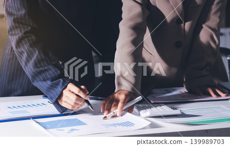 Accountants processing financial documents and taxes, managing corporate finance in a modern office. Audit and taxes in business Accountants processing financial documents and taxes, managing corporate finance in a modern office. Audit and taxes in business 139989703