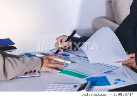 Accountants processing financial documents and taxes, managing corporate finance in a modern office. Audit and taxes in business Accountants processing financial documents and taxes, managing corporate finance in a modern office. Audit and taxes in business 139989714