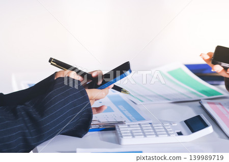 Accountants processing financial documents and taxes, managing corporate finance in a modern office. Audit and taxes in business 139989719