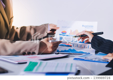 Accountants processing financial documents and taxes, managing corporate finance in a modern office. Audit and taxes in business Accountants processing financial documents and taxes, managing corporate finance in a modern office. Audit and taxes in business 139989728