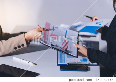 Accountants processing financial documents and taxes, managing corporate finance in a modern office. Audit and taxes in business Accountants processing financial documents and taxes, managing corporate finance in a modern office. Audit and taxes in business 139989732
