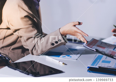 Accountants processing financial documents and taxes, managing corporate finance in a modern office. Audit and taxes in business Accountants processing financial documents and taxes, managing corporate finance in a modern office. Audit and taxes in business 139989733