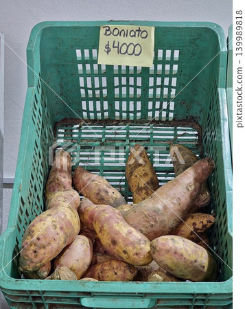 Cordoba, Argentina - April 9, 2026: pale sweet potatoes displayed in green crate Cordoba, Argentina - April 9, 2026: pale sweet potatoes displayed in green crate 139989818