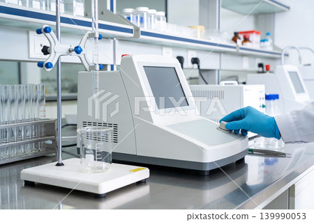 Scientist operating advanced laboratory equipment with digital display and touchscreen interface Scientist operating advanced laboratory equipment with digital display and touchscreen interface 139990053