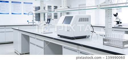 Modern laboratory equipment with scientific instruments and glassware on a clean bench Modern laboratory equipment with scientific instruments and glassware on a clean bench 139990060