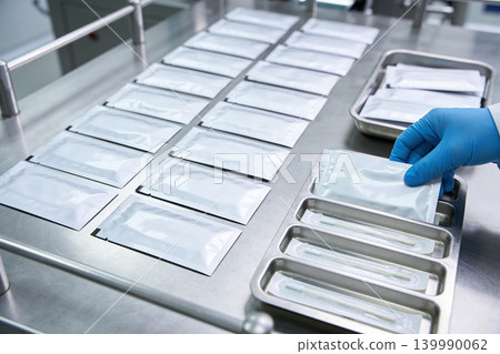 Medical testing kits being prepared for distribution in a sterile laboratory environment Medical testing kits being prepared for distribution in a sterile laboratory environment 139990062