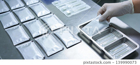 Sterile medical supplies being organized in a clean room laboratory setting Sterile medical supplies being organized in a clean room laboratory setting 139990073