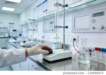 Scientist in lab coat adjusts equipment for chemical analysis in a modern laboratory setting Scientist in lab coat adjusts equipment for chemical analysis in a modern laboratory setting 139990075