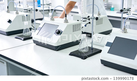 Modern laboratory equipment with digital displays and glassware for scientific research 139990178