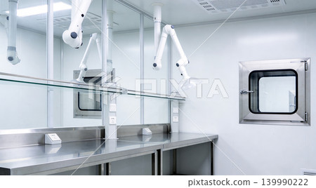Modern laboratory cleanroom with stainless steel benches and fume extraction arms Modern laboratory cleanroom with stainless steel benches and fume extraction arms 139990222