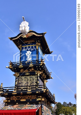 The Inuyama Festival in Aichi Prefecture, Japan: A magnificent procession of elaborate floats called "Kurumayama" and the keep of Inuyama Castle, under a sky full of blooming cherry blossoms. The Inuyama Festival in Aichi Prefecture, Japan: A magnificent procession of elaborate floats called "Kurumayama" and the keep of Inuyama Castle, under a sky full of blooming cherry blossoms. 139990349