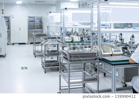 Modern cleanroom assembly line with stainless steel carts and equipment 139990412
