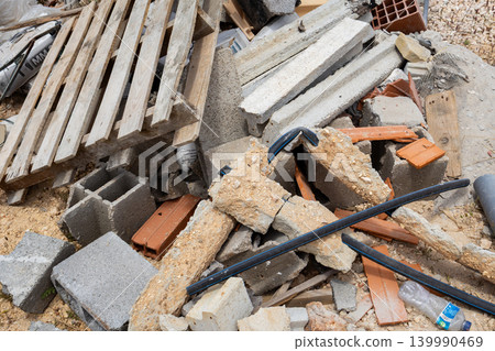 Pile of construction debris with wooden pallet and broken concrete blocks Pile of construction debris with wooden pallet and broken concrete blocks 139990469