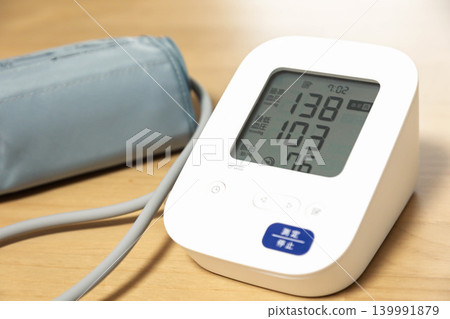 Blood pressure monitor indicates slightly high blood pressure. Blood pressure monitor indicates slightly high blood pressure. 139991879