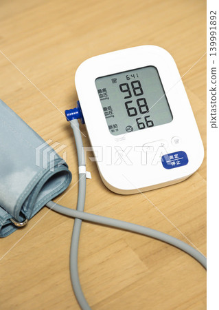 Blood pressure monitor indicates slightly low blood pressure. Blood pressure monitor indicates slightly low blood pressure. 139991892