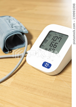 Blood pressure monitor indicates slightly low blood pressure. Blood pressure monitor indicates slightly low blood pressure. 139991898