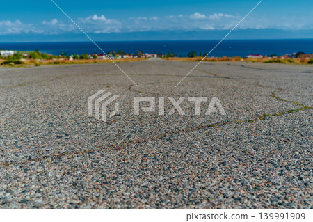 Empty wide paved road on sea background Empty wide paved road on sea background 139991909