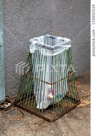 Empty plastic trash bin on street Empty plastic trash bin on street 139992034