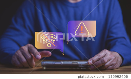 Man holding smartphone with no wifi signal and warning icon for internet connection problem, technology error, and disconnected network issues alert. Man holding smartphone with no wifi signal and warning icon for internet connection problem, technology error, and disconnected network issues alert. 139992406