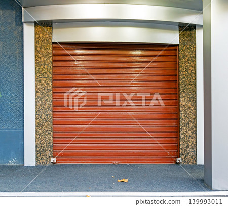 Closed metal garage door on street Closed metal garage door on street 139993011