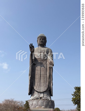 A full view of the gigantic Buddha statue towering against the blue sky. A full view of the gigantic Buddha statue towering against the blue sky. 139993688