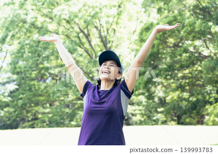 A woman stretching in the park A woman stretching in the park 139993783