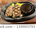Juicy hamburger steak grilled on a sizzling hot plate 139993793