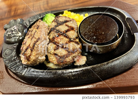 Juicy hamburger steak grilled on a sizzling hot plate Juicy hamburger steak grilled on a sizzling hot plate 139993793