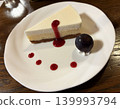 Rich no-bake cheesecake topped with berry sauce 139993794
