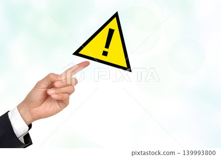 Warning mark and a man's hands Warning mark and a man's hands 139993800