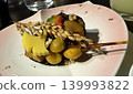A creative Japanese appetizer plate beautifully adorned with rice stalks and ginkgo leaves. 139993822