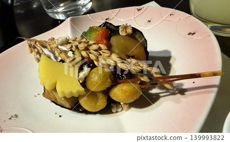 A creative Japanese appetizer plate beautifully adorned with rice stalks and ginkgo leaves. A creative Japanese appetizer plate beautifully adorned with rice stalks and ginkgo leaves. 139993822
