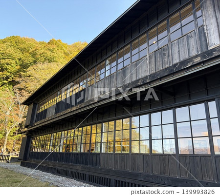 A beautiful historic Western-style building with black-painted wooden architecture. 139993826