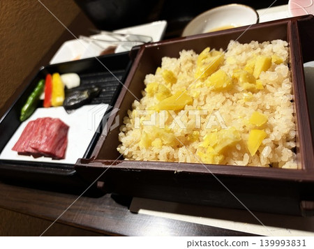 Steamed chestnut rice, a taste of autumn, in a piping hot bamboo steamer. Steamed chestnut rice, a taste of autumn, in a piping hot bamboo steamer. 139993831