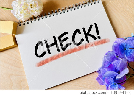 A ring notebook and sticky notes labeled "Check". A ring notebook and sticky notes labeled "Check". 139994164