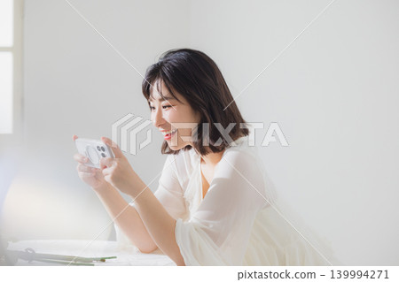 Woman operating a smartphone Woman operating a smartphone 139994271