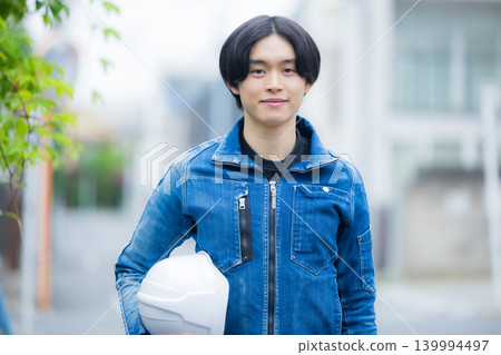A young worker operating a smartphone 139994497